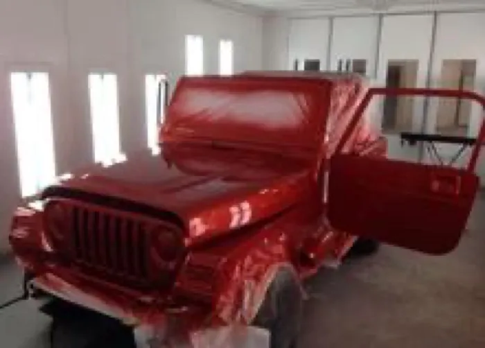 Vehicle undergoing expert paint work in the Apex Auto Body paint booth